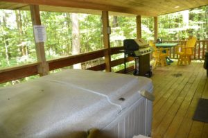 deck of The Landing log cabin with hot tub