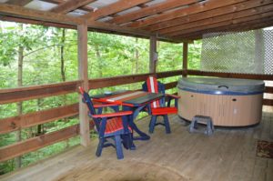 deck with hot tub at Nature's Paradise log cabin