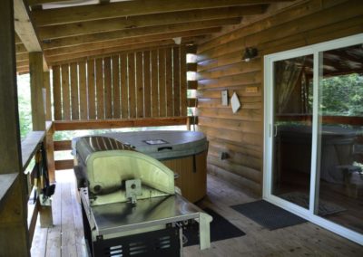 deck with hot tub and gas grill