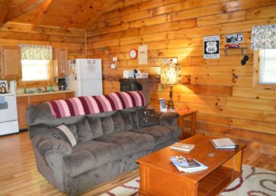 entertainment area and kitchen in Yesteryear log cabin