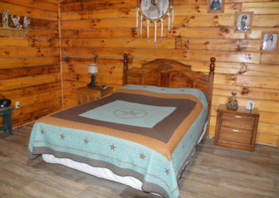 rustic bedroom with queen bed at Trail Ridge cabin